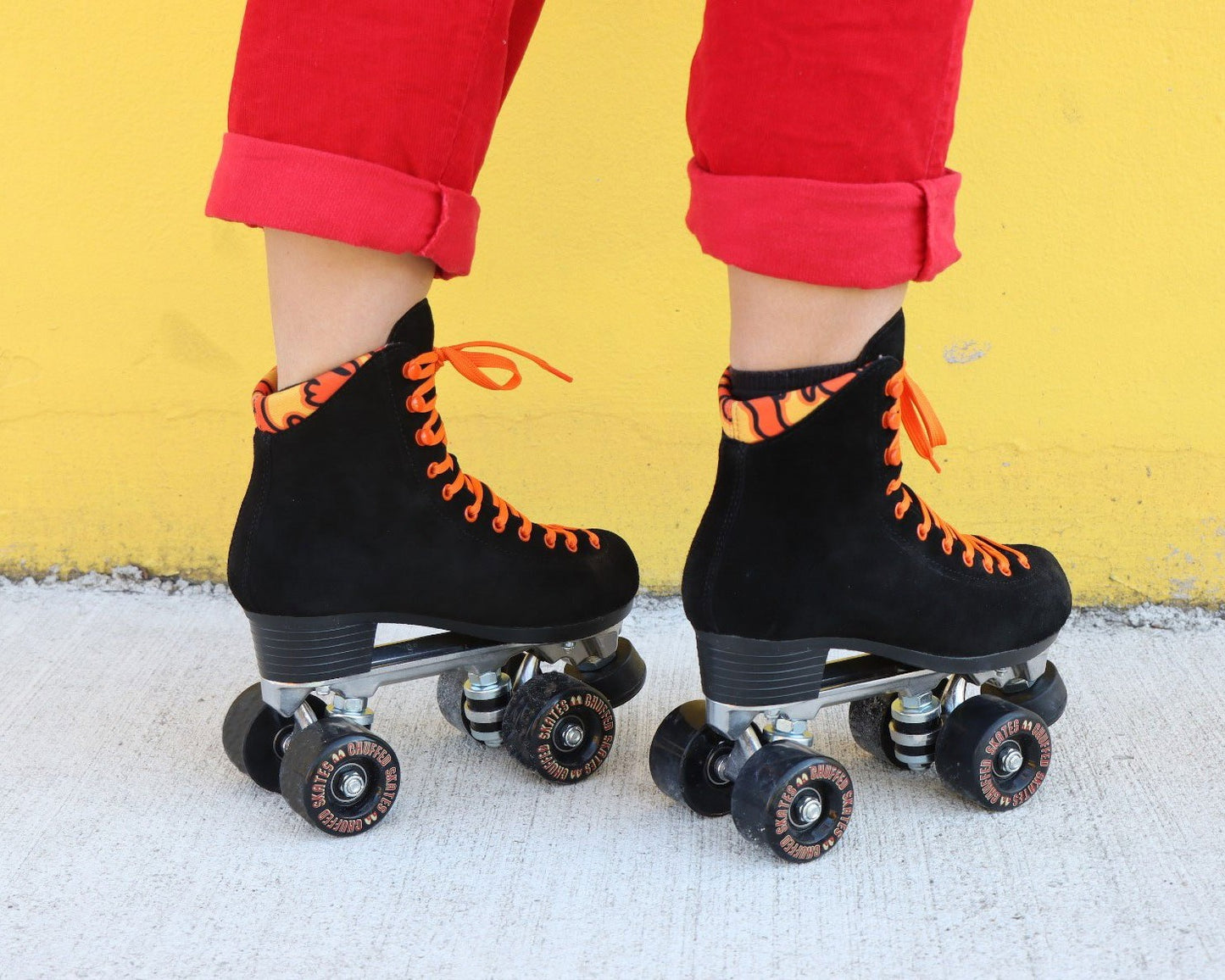 Chuffed Skates black roller skates with yellow background